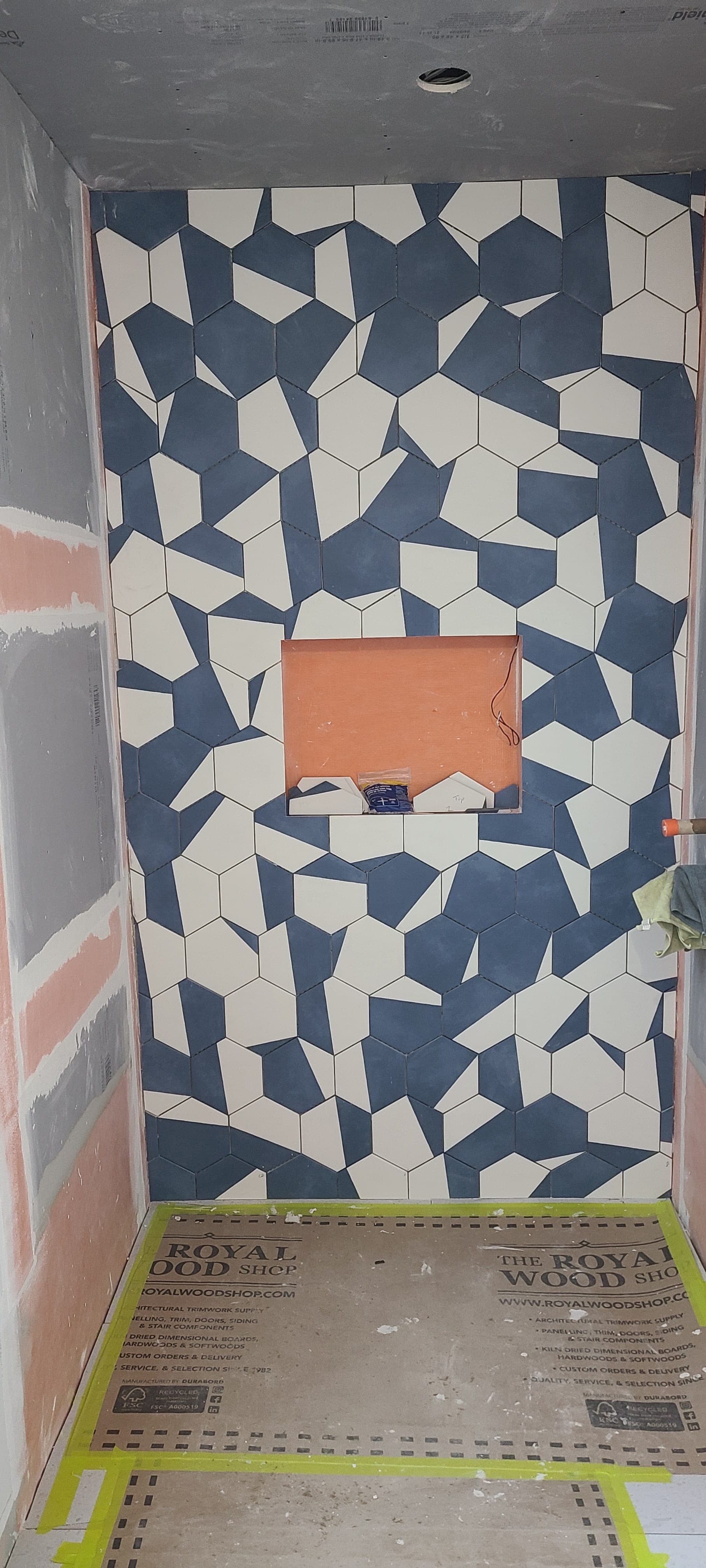 Custom blue and white geometric hex mosaic feature wall, in progress