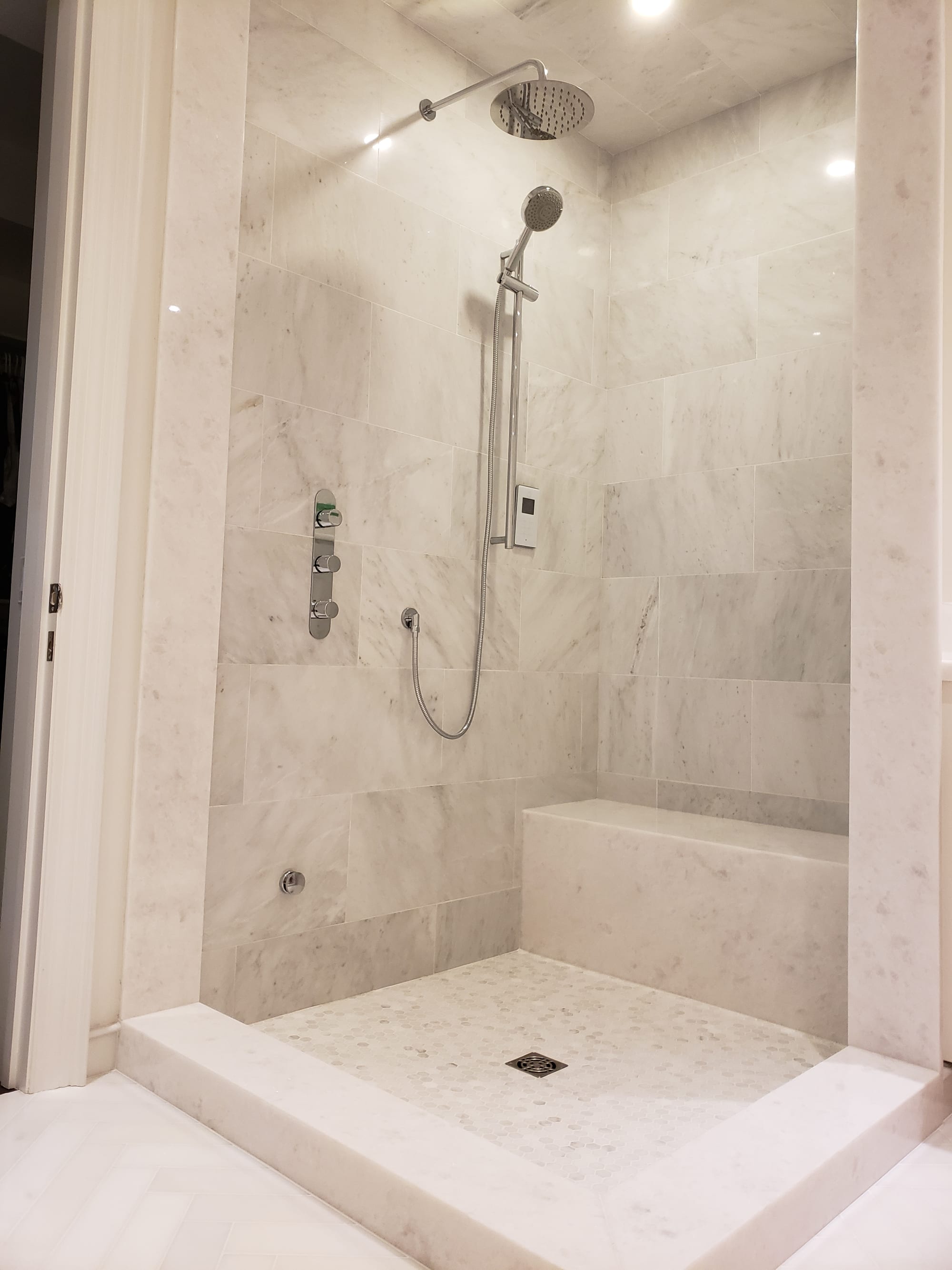 Carrara marble walk-in shower — master bathroom renovation by Blue Tile & Marble